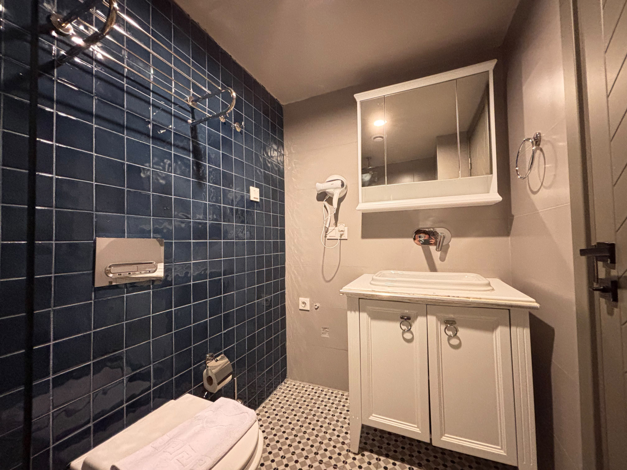 Representative photo of this studio type: bathroom with a basin, mirror, wall-mounted hair dryer and toilet.